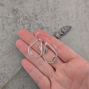 Sterling silver teardrop hoop earrings with dainty feather accents