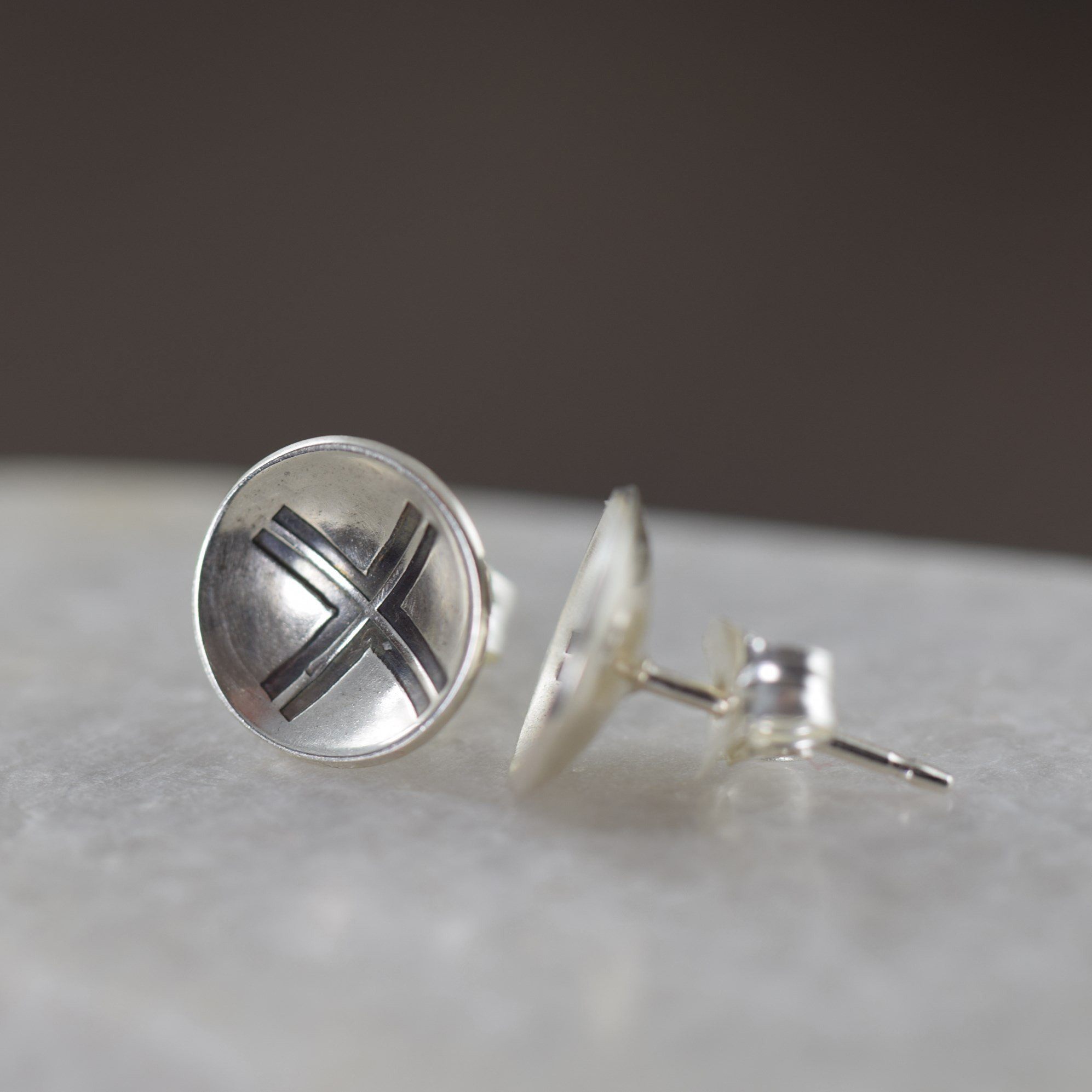 Unisex sterling silver stud earrings featuring a modern cross