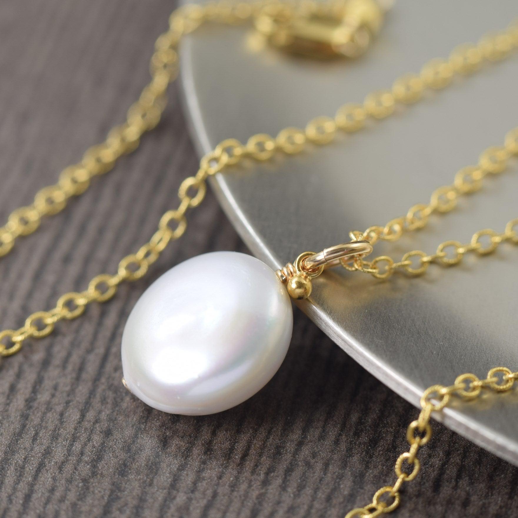 White freshwater pearl necklace on gold filled chain coin shape